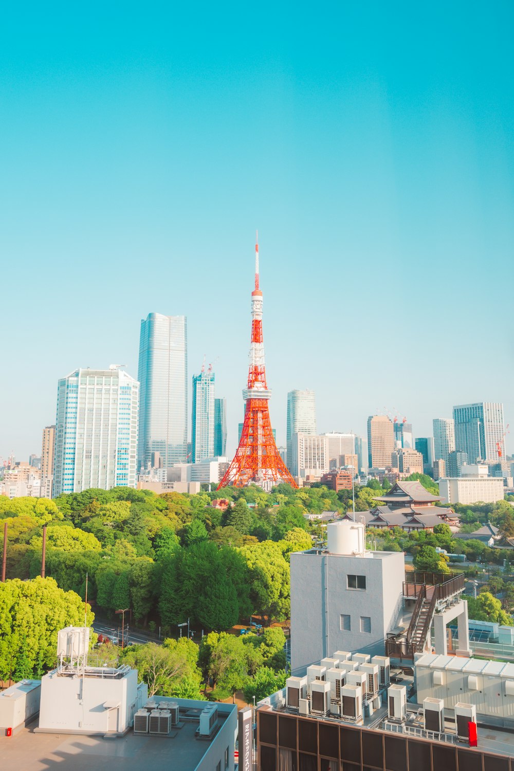 a view of a city with a red tower in the middle