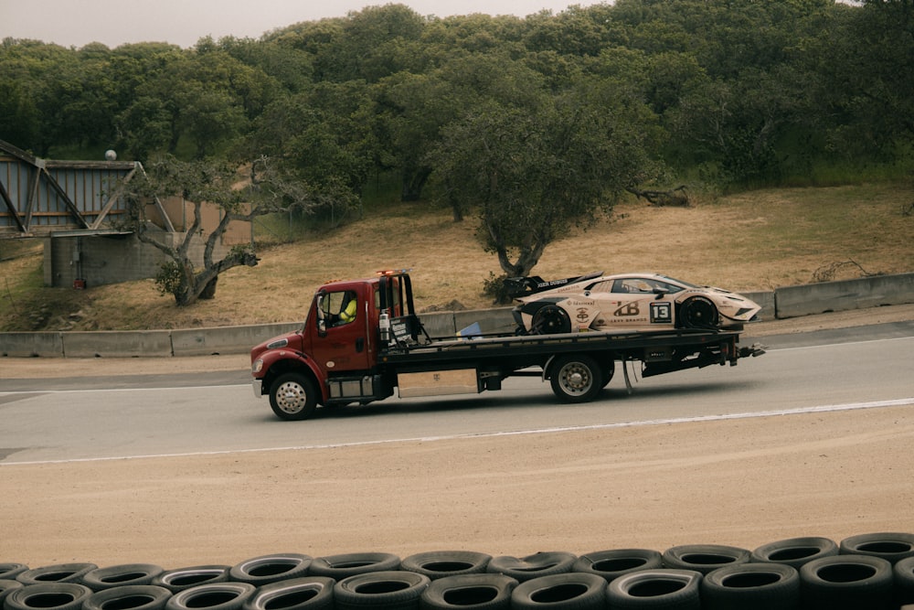 a tow truck hauling a car down a road