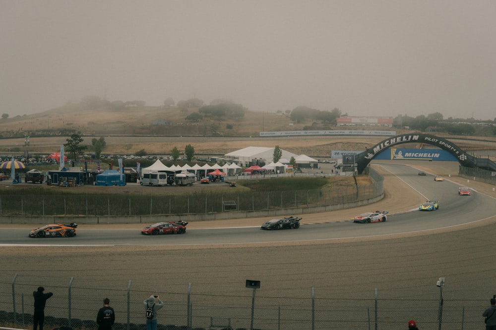 a group of cars driving down a race track