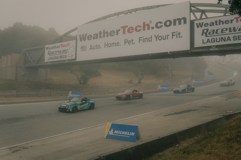 a group of cars driving down a race track