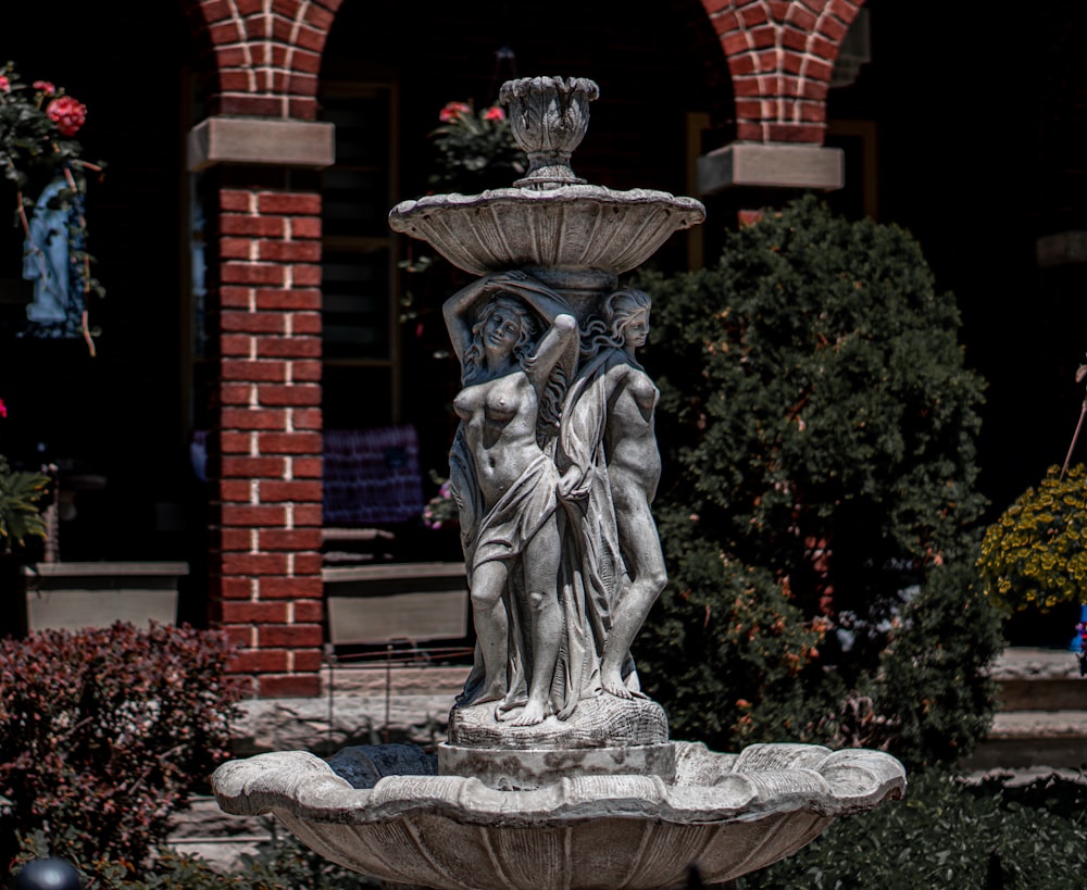 a statue of a man and a woman in a fountain