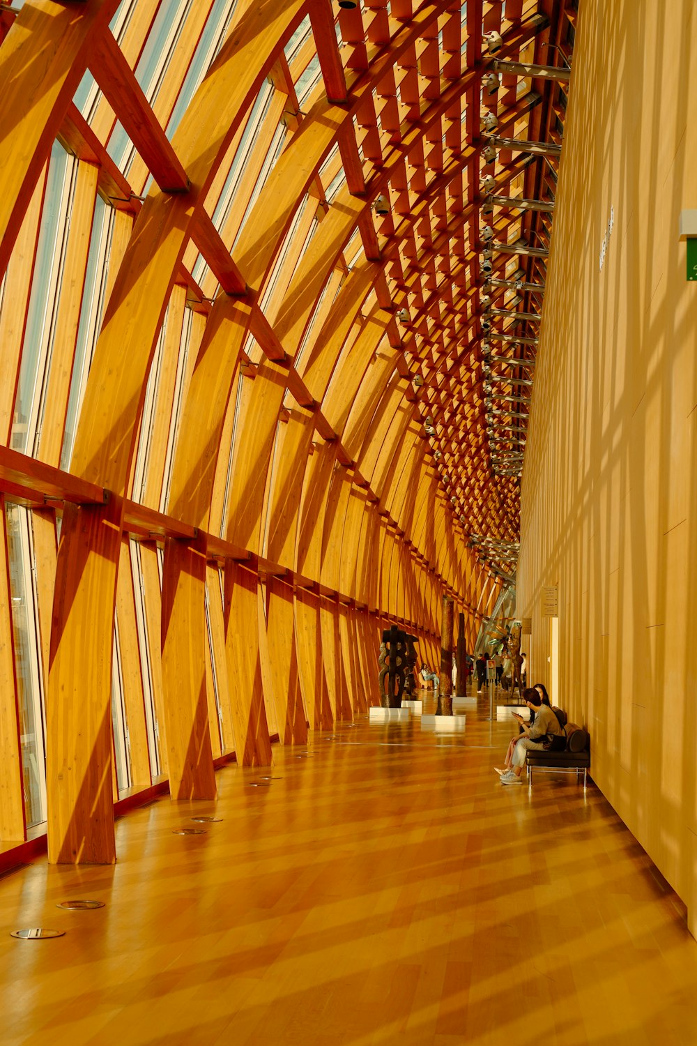 a large room with a wooden ceiling and wooden floors