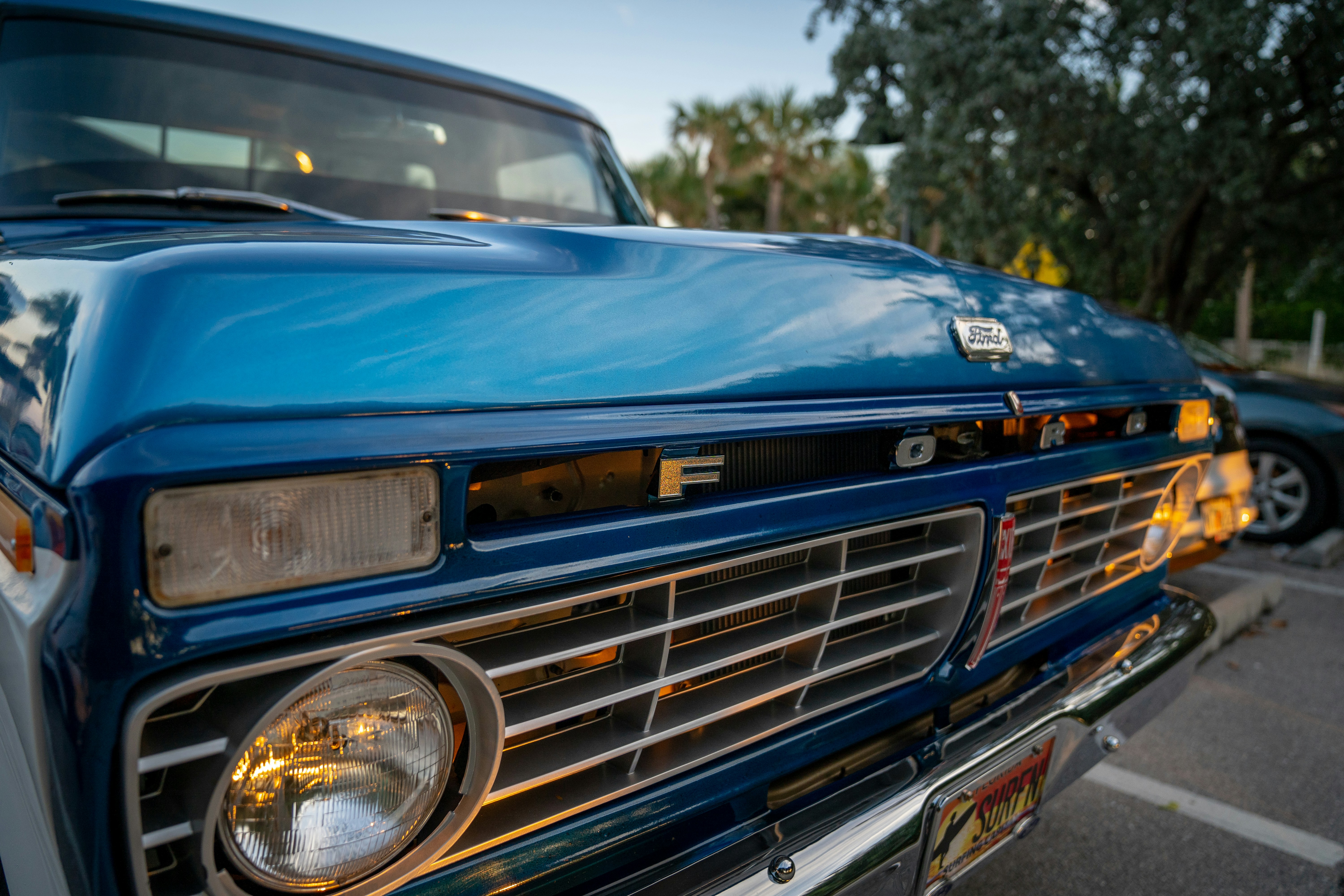Close-up shot of a classic red pickup truck's front grille and headlights.