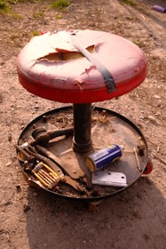 A finished wooden stool displayed on a workbench with tools around.