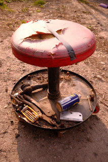 A sturdy industrial workshop stool standing ready beside a busy workbench.