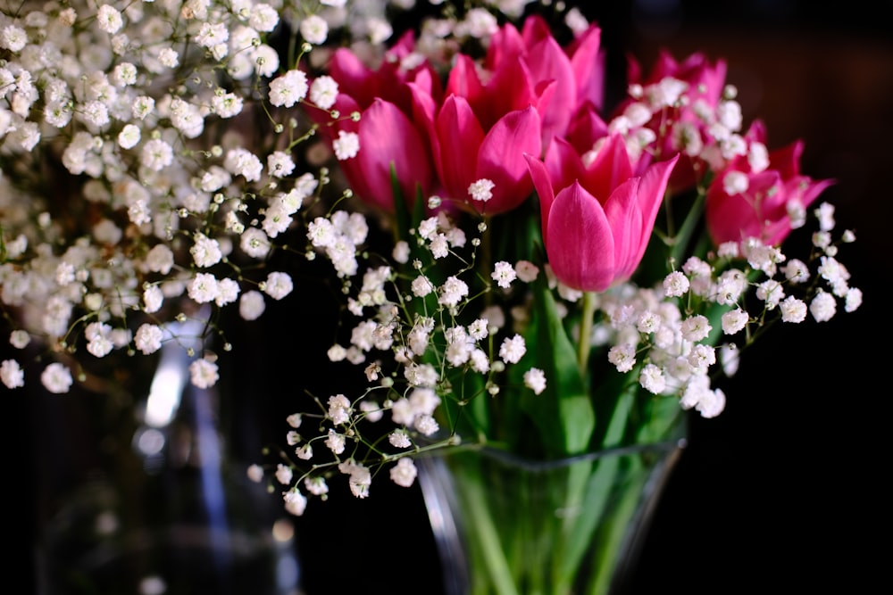 a vase filled with pink and white flowers