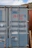 Close-up of a sturdy custom container door with a satisfied customer inspecting it.