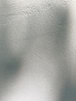 Detail of professional paint finish on a smooth white wall.