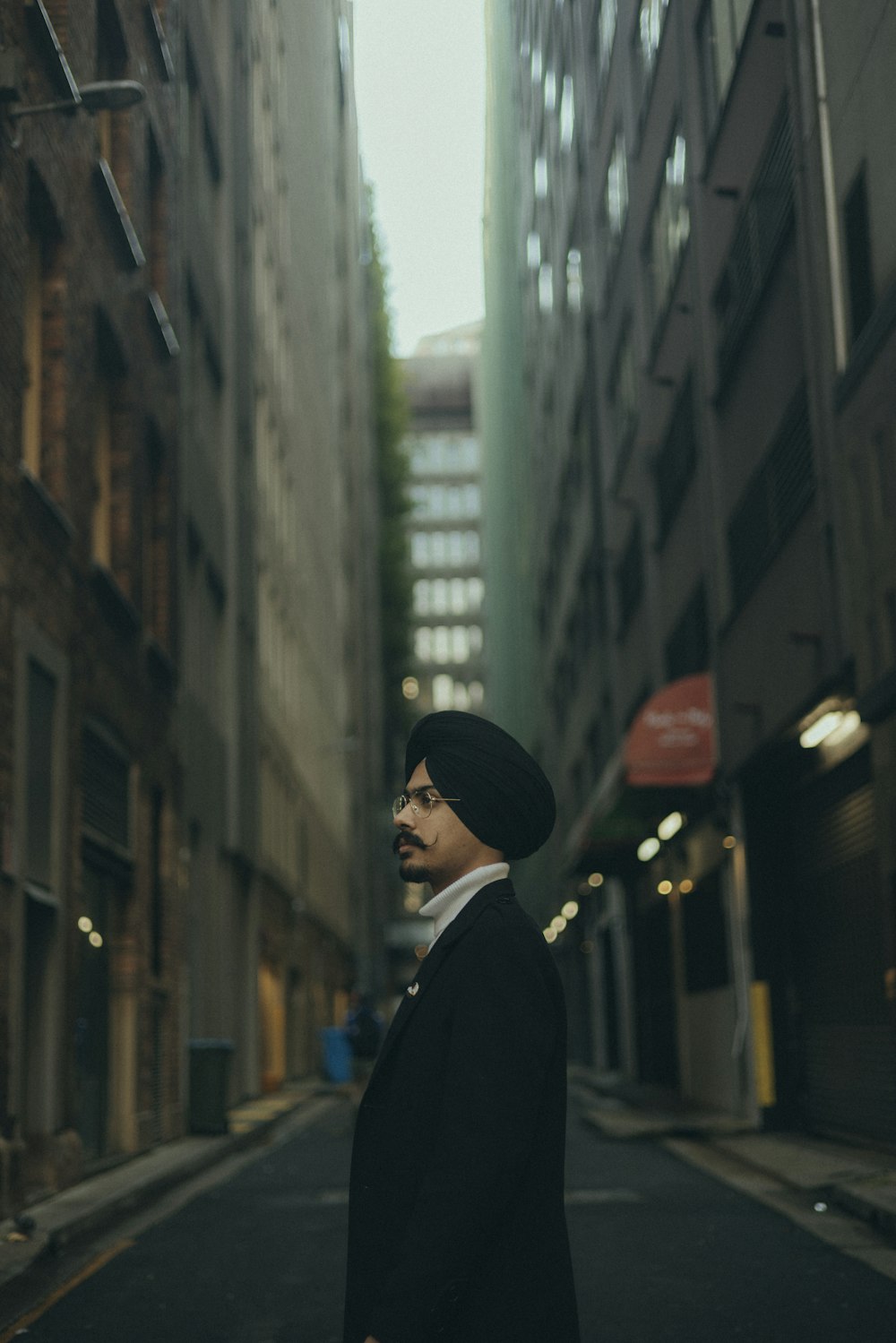 a man in a turban standing in the middle of a street