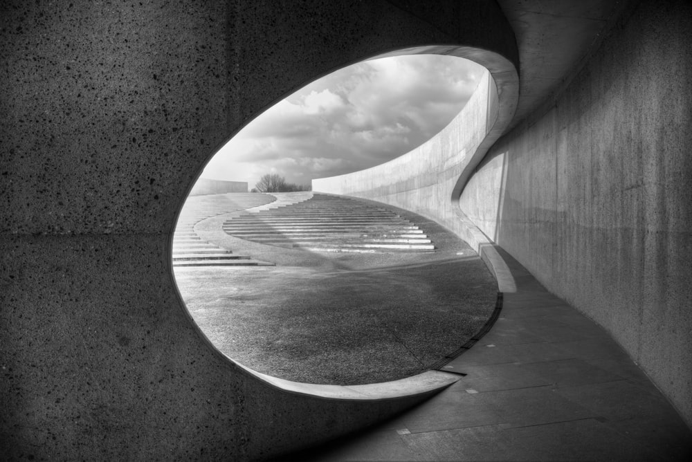 a black and white photo of a curved concrete wall
