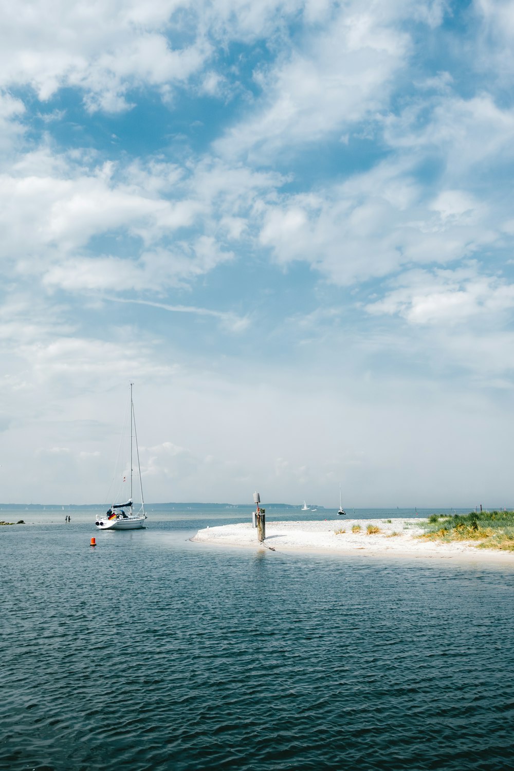 a man standing on a beach next to a boat