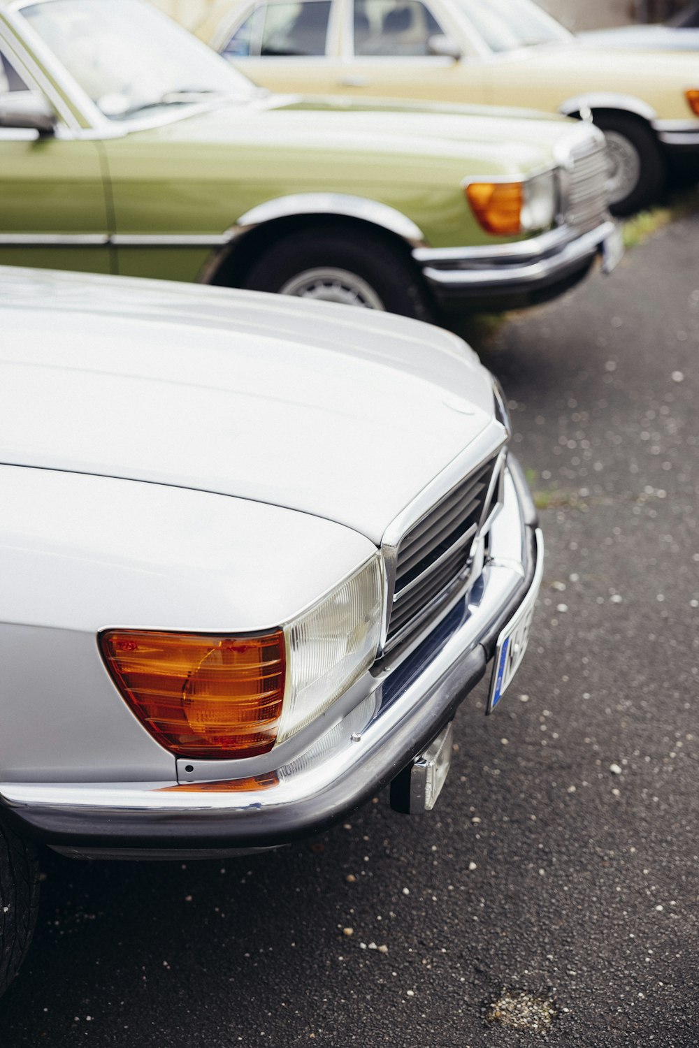 a row of parked cars sitting next to each other