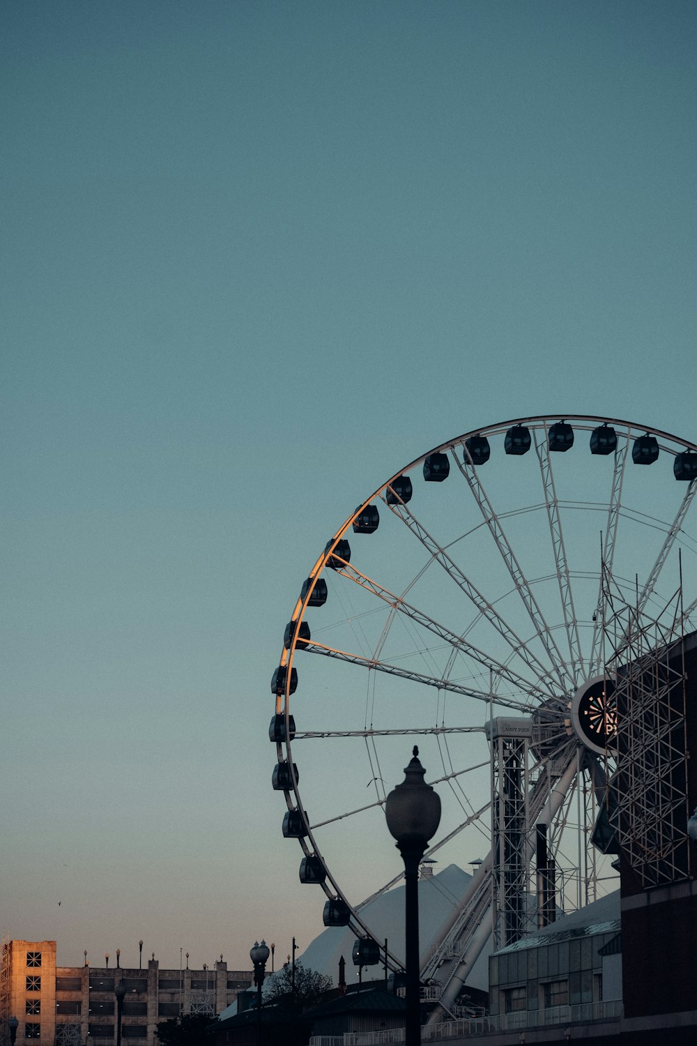 a large ferris wheel sitting next to a tall building