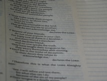 A close-up of a page with text, possibly from a religious or spiritual book, featuring numbered paragraphs and a structured layout. The text is clearly printed and fills the left side of the page, with margins and a dotted line on the right.