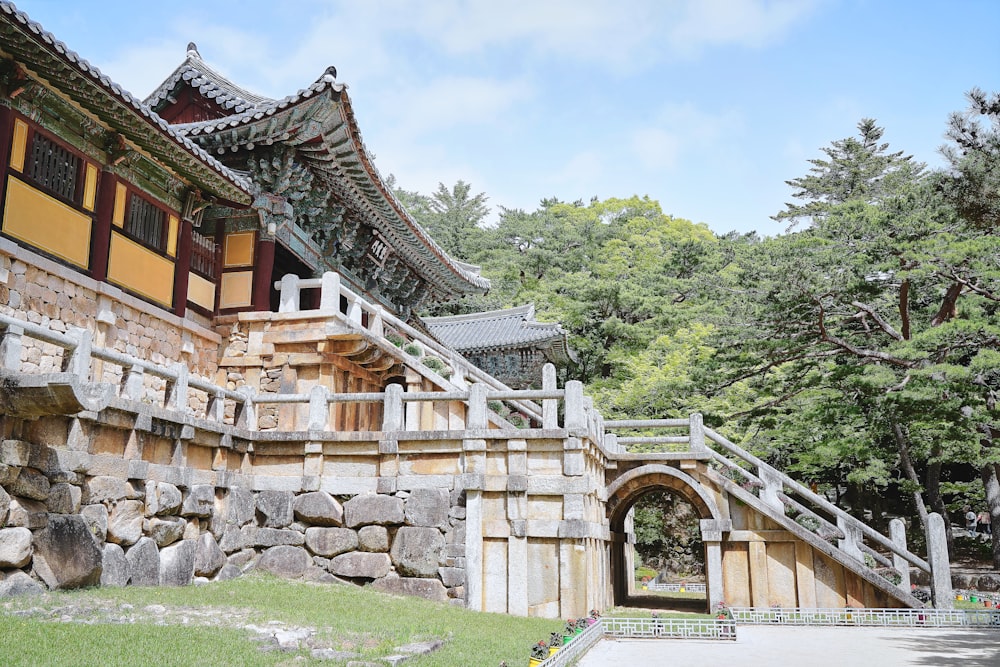 a stone building with a gate and steps leading to it