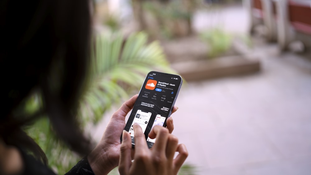 a woman holding a smart phone in her hand