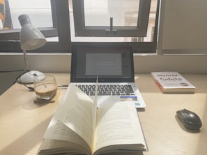 A cozy workspace with a laptop open to an e-book about personal development.