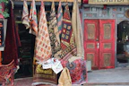 A cozy display of colorful handwoven door mats at an inviting doorstep.