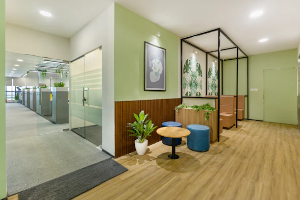 A warm, inviting office space with green accents reflecting Bauzenmx's brand colors.