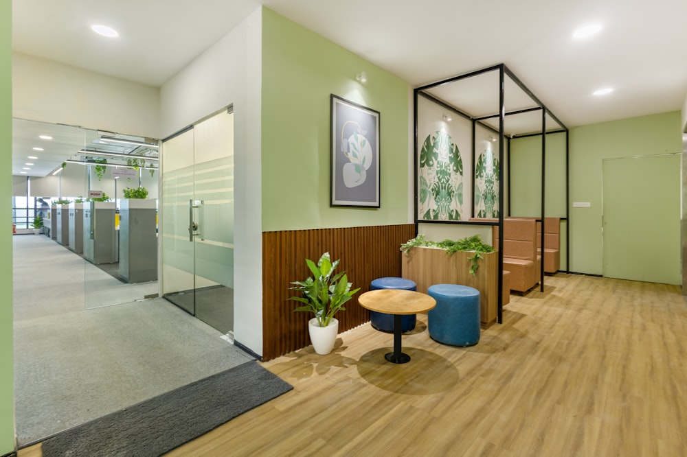 an office with a wooden floor and green walls