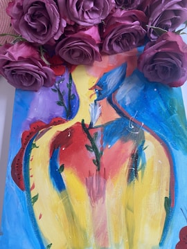 A vibrant acrylic painting of wildflowers displayed on a rustic wooden easel.