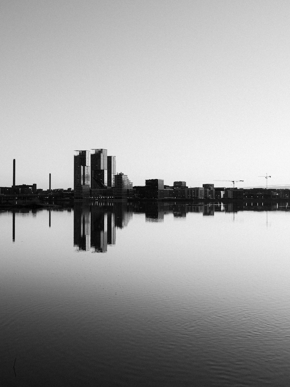 a large body of water with a city in the background