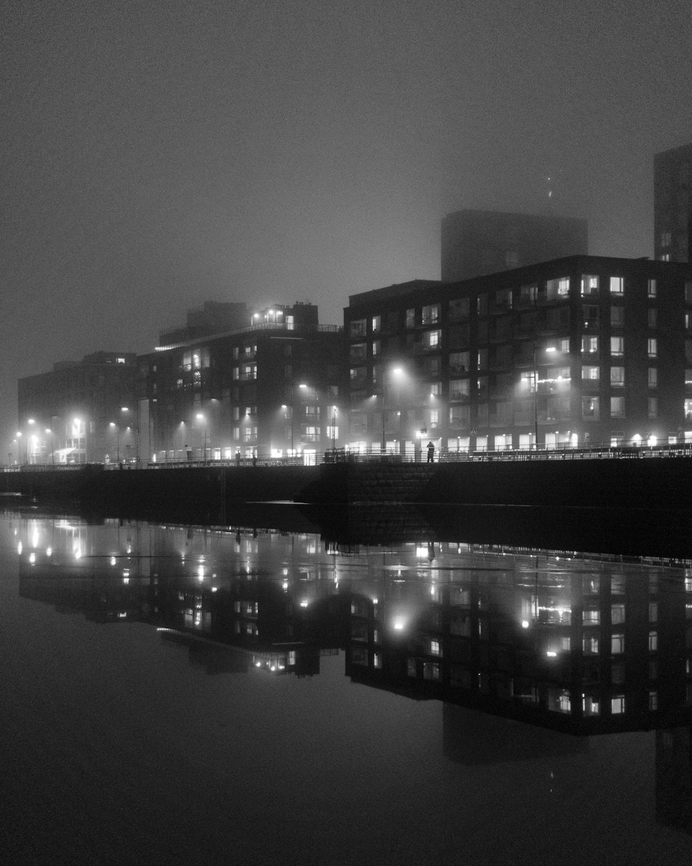 a black and white photo of a city at night