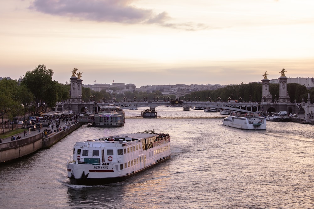 a boat traveling down a river next to a bridge