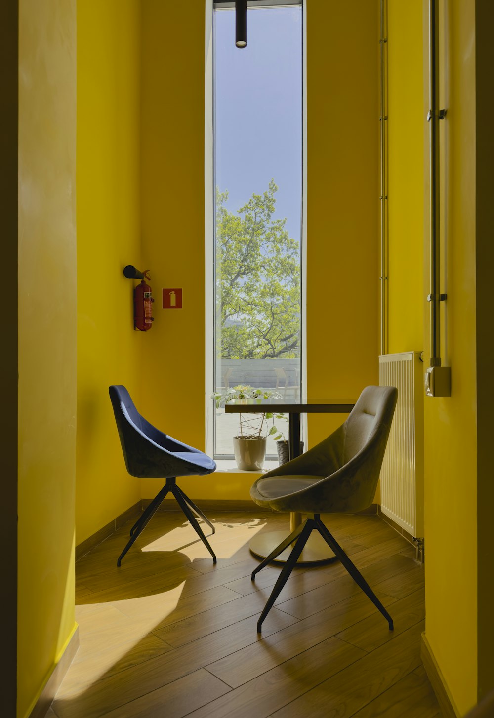 a room with yellow walls and a table and chairs