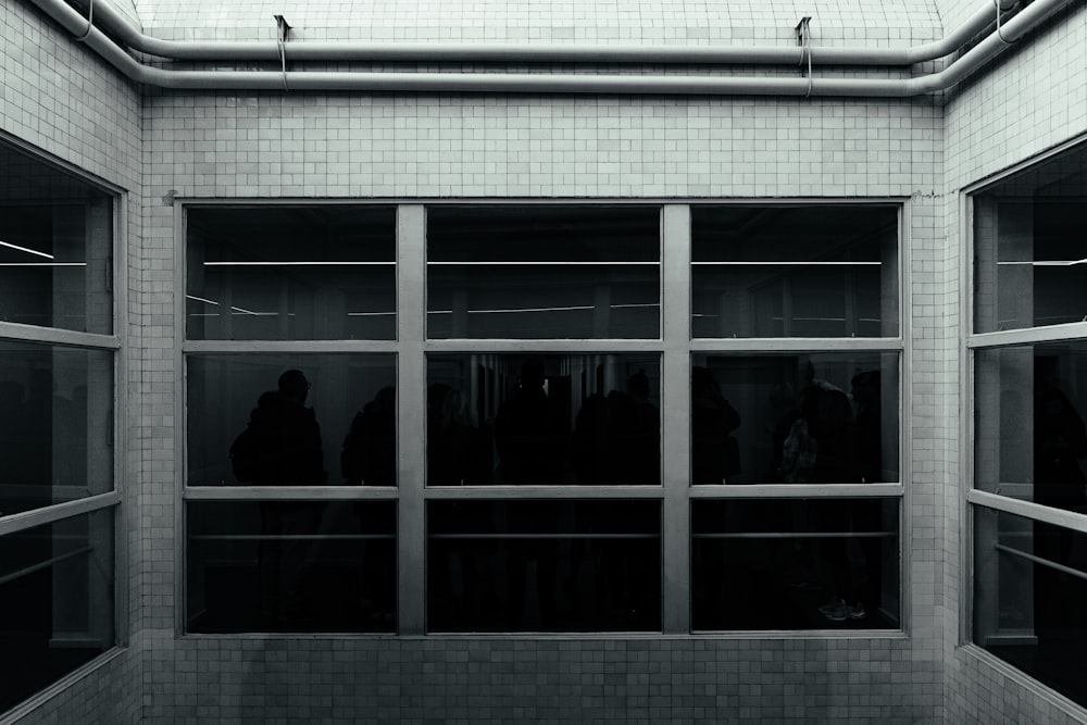 a black and white photo of people in a room