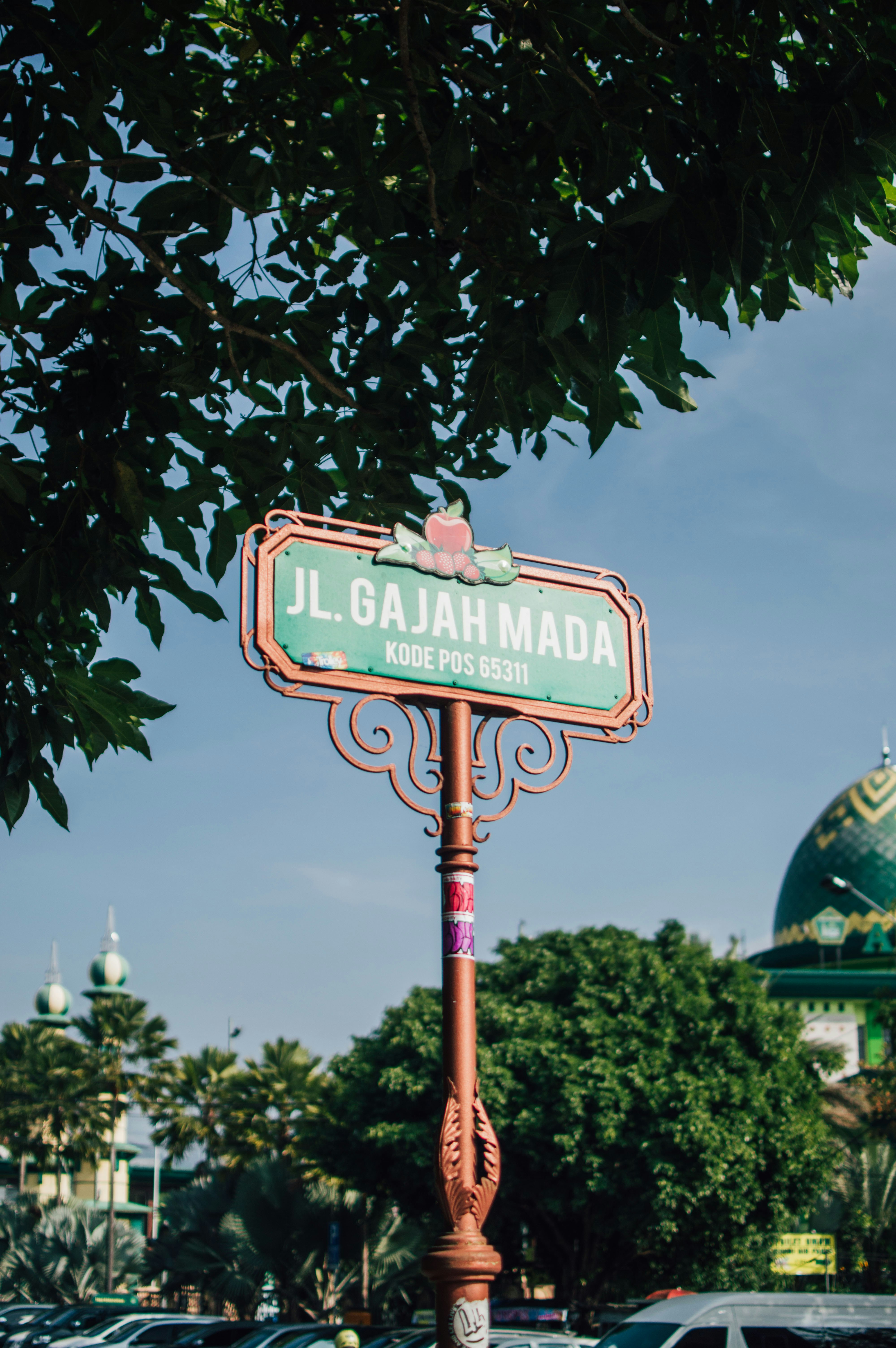 a street sign in front of a green dome