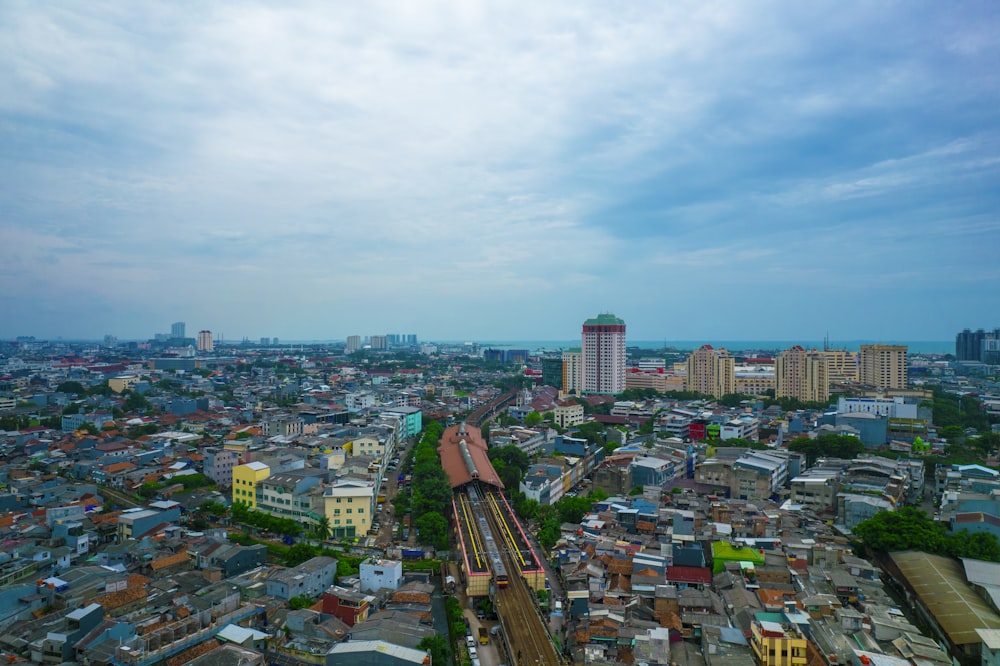 an aerial view of a city with a train on the tracks