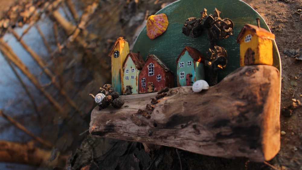 a group of small houses sitting on top of a tree stump