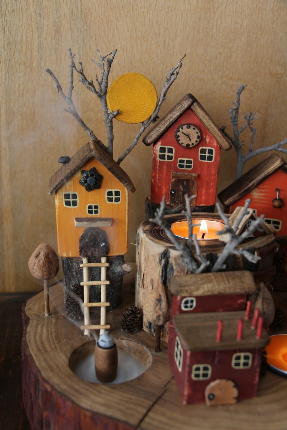 a group of small houses sitting on top of a tree stump