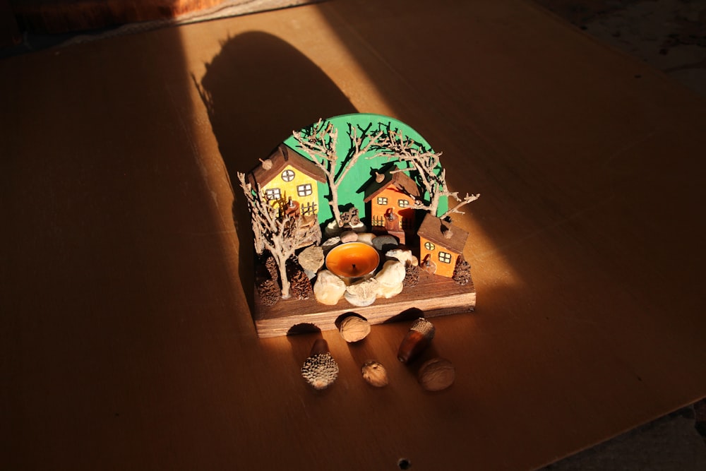 a small wooden clock sitting on top of a table