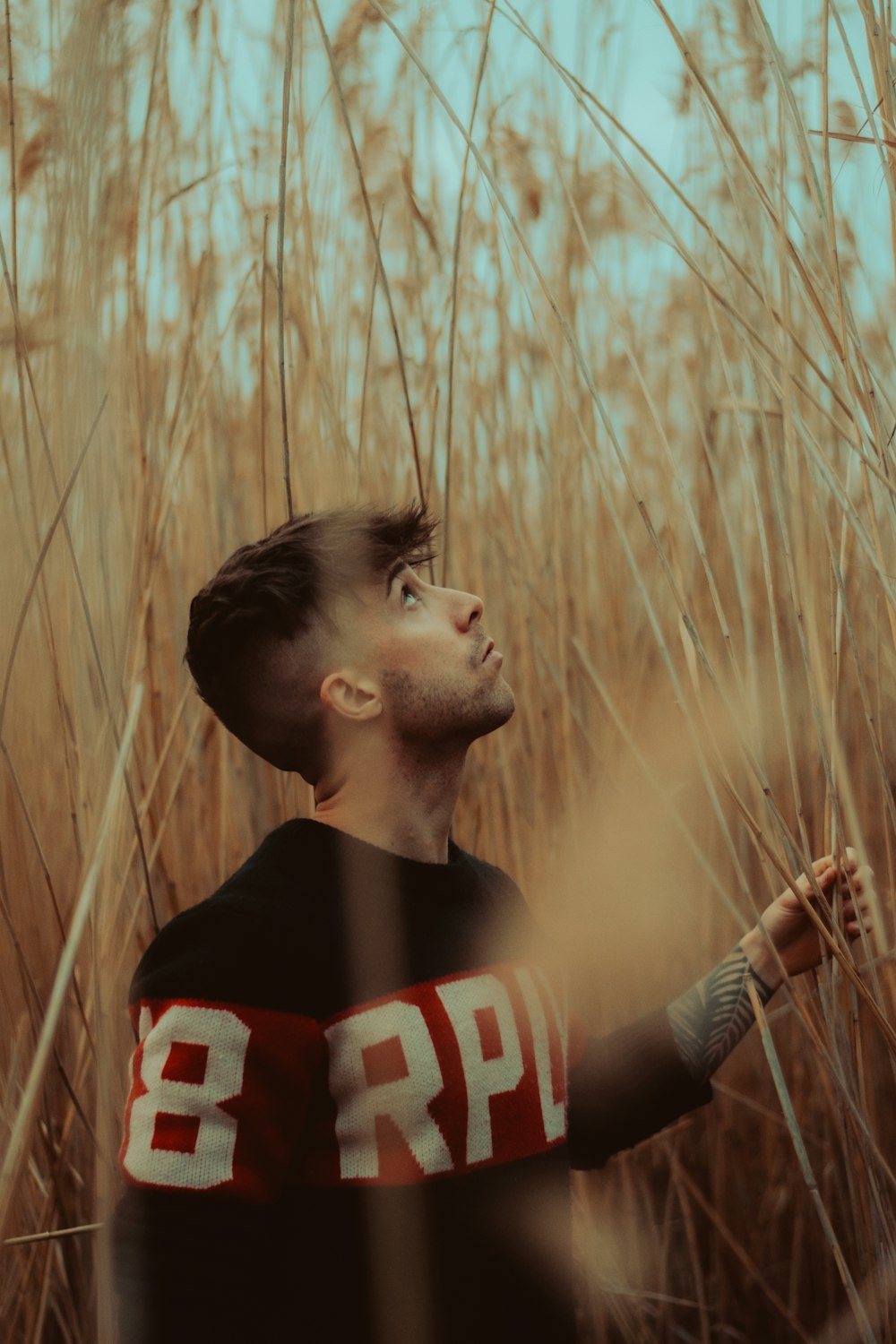 a man standing in a field of tall grass