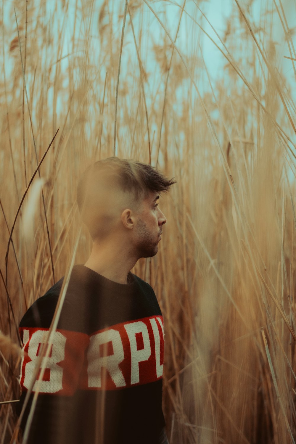 a man standing in a field of tall grass