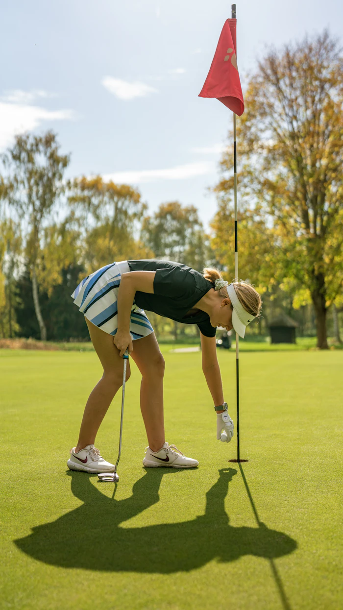 Golfer lining up a putt on the green