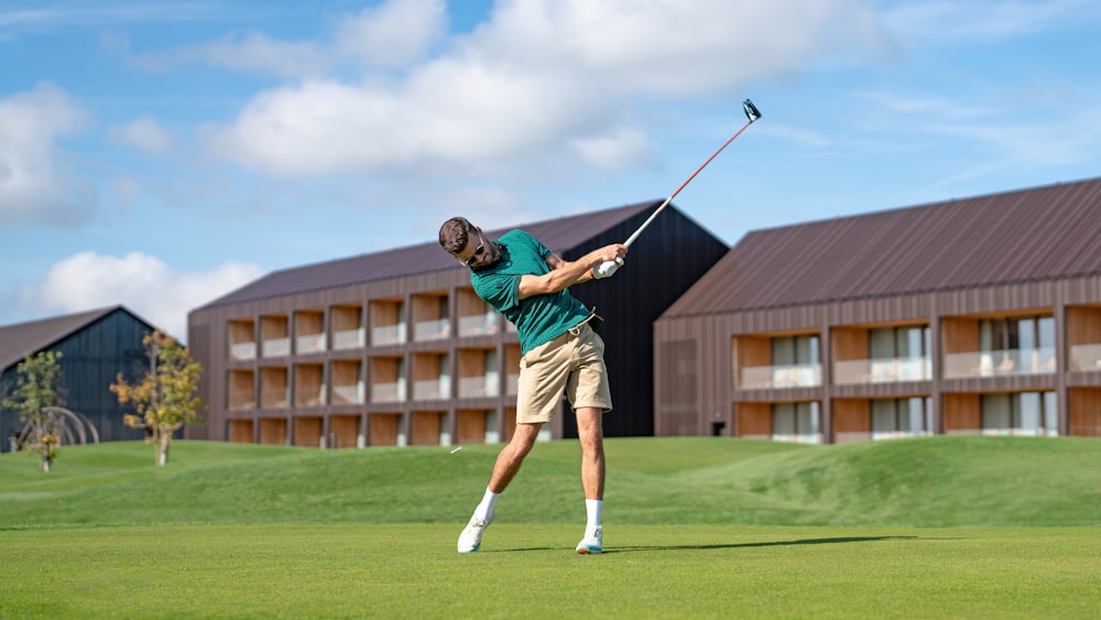 a man swinging a golf club on a golf course