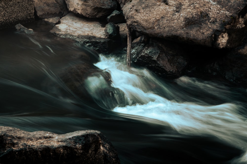a stream of water running between some rocks