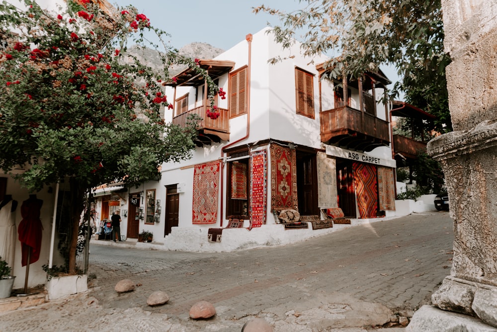 a white building with red decorations on the windows