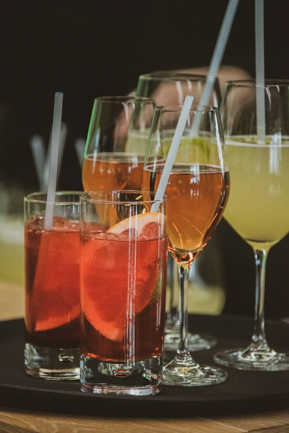 a group of glasses filled with different types of drinks