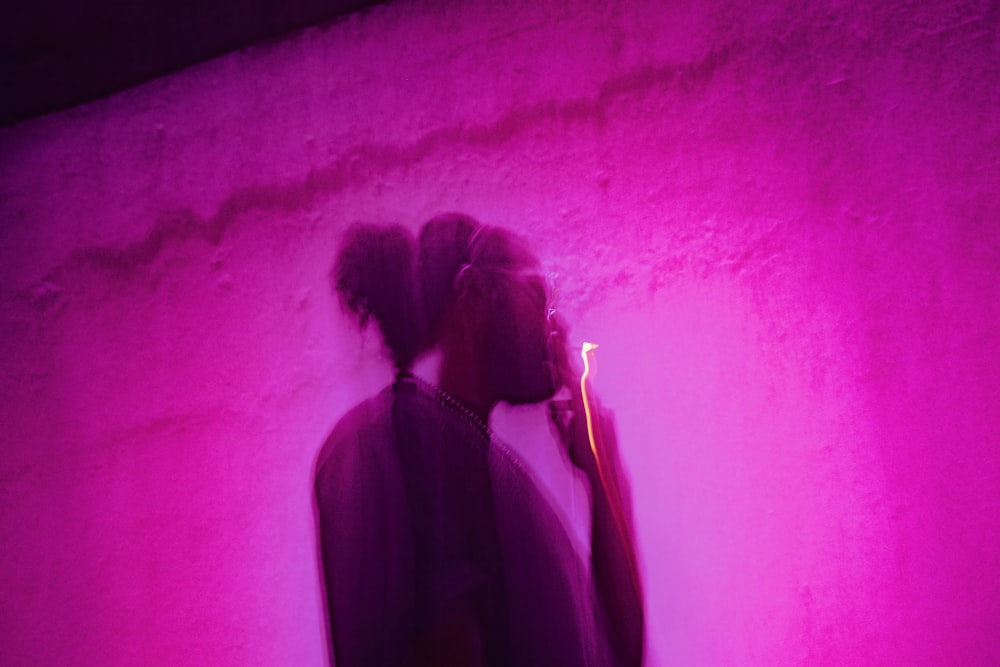 a woman standing in front of a purple light
