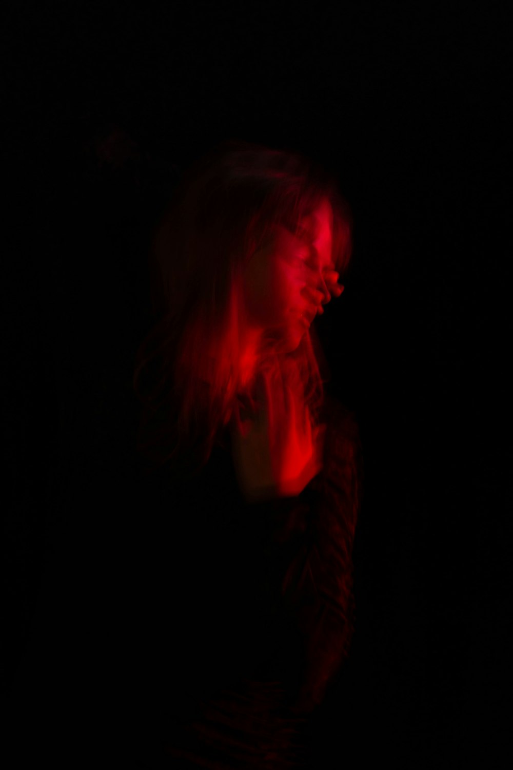 a blurry image of a woman in the dark