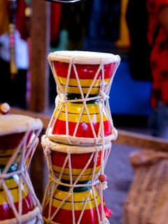 A close-up of a traditional dholki drum being played during a lively Marathi folk performance