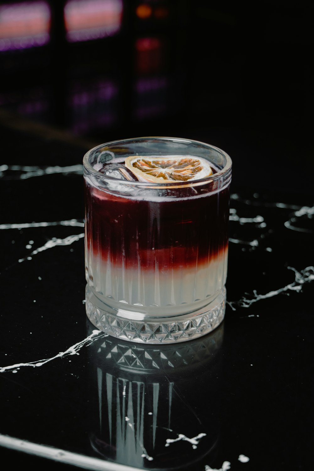 a glass with a dessert inside of it on a table