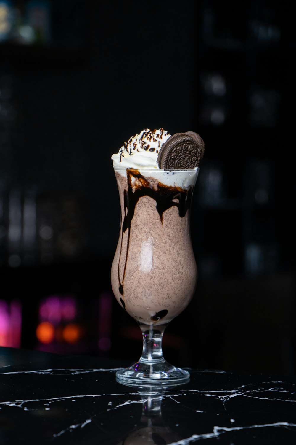 a chocolate milkshake with a cookie on top