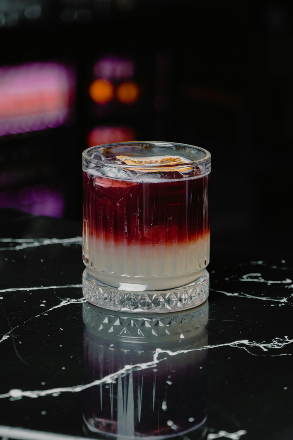 a glass filled with liquid sitting on top of a table