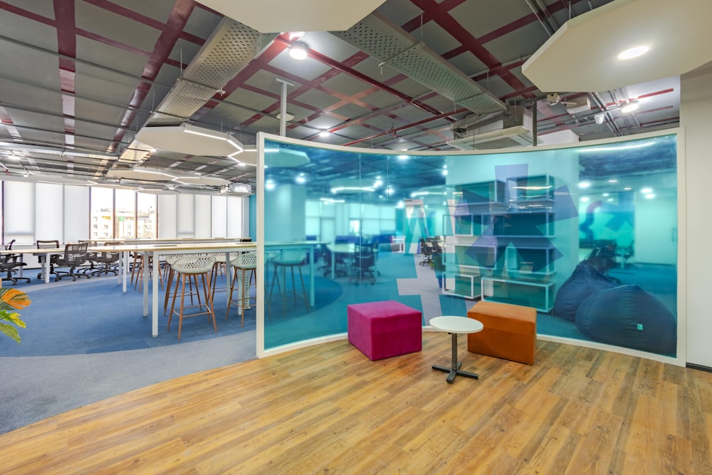 a room with a glass wall and chairs