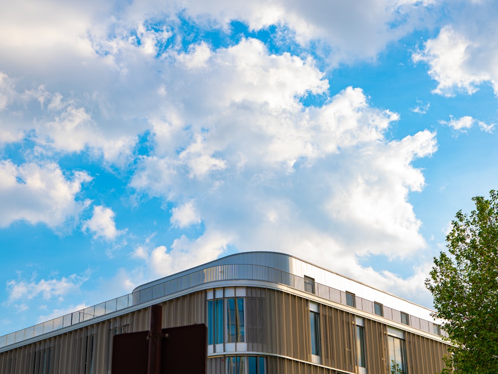 a building with a lot of windows under a cloudy blue sky